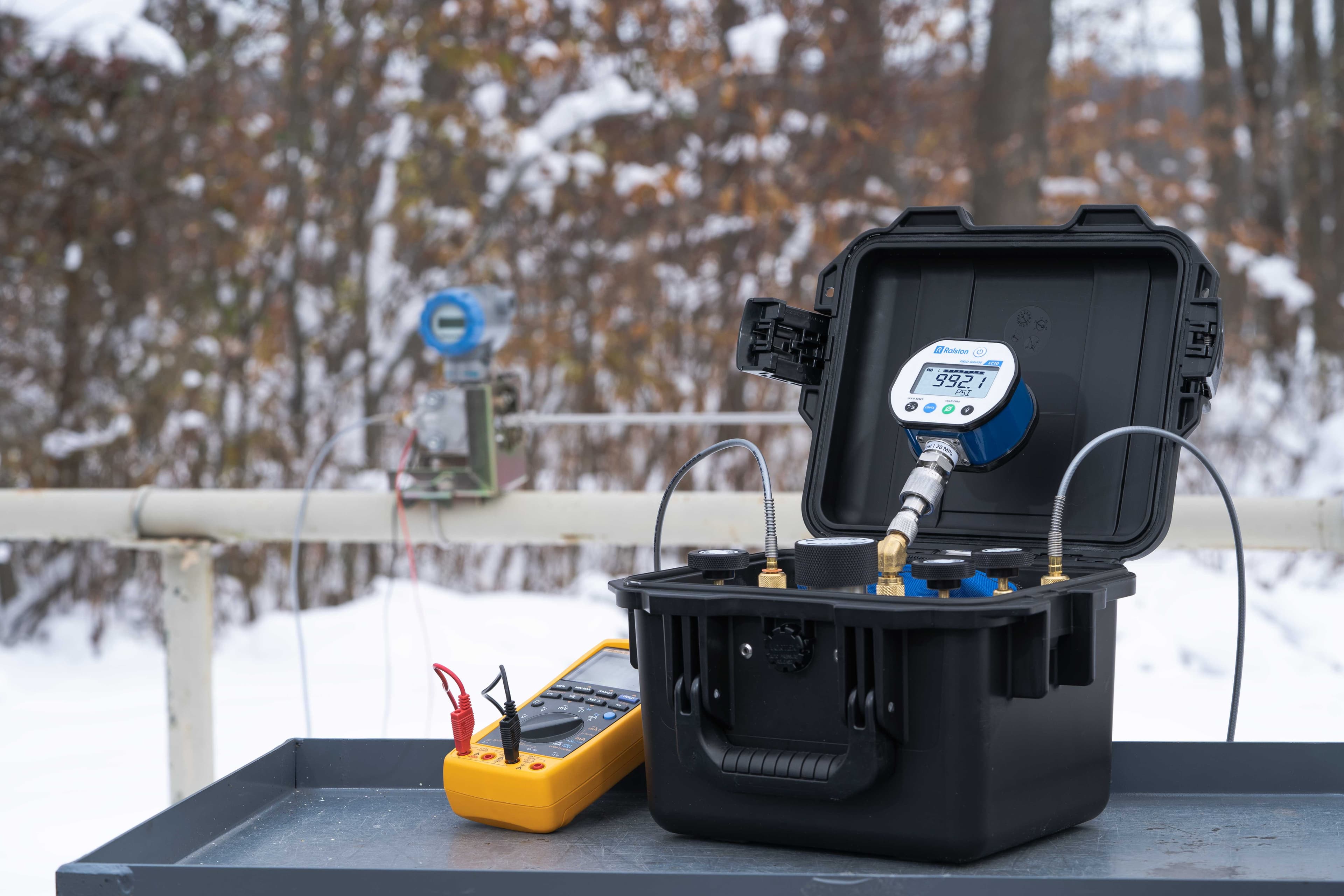 Portable calibration kit with digital pressure gauge in an outdoor setting