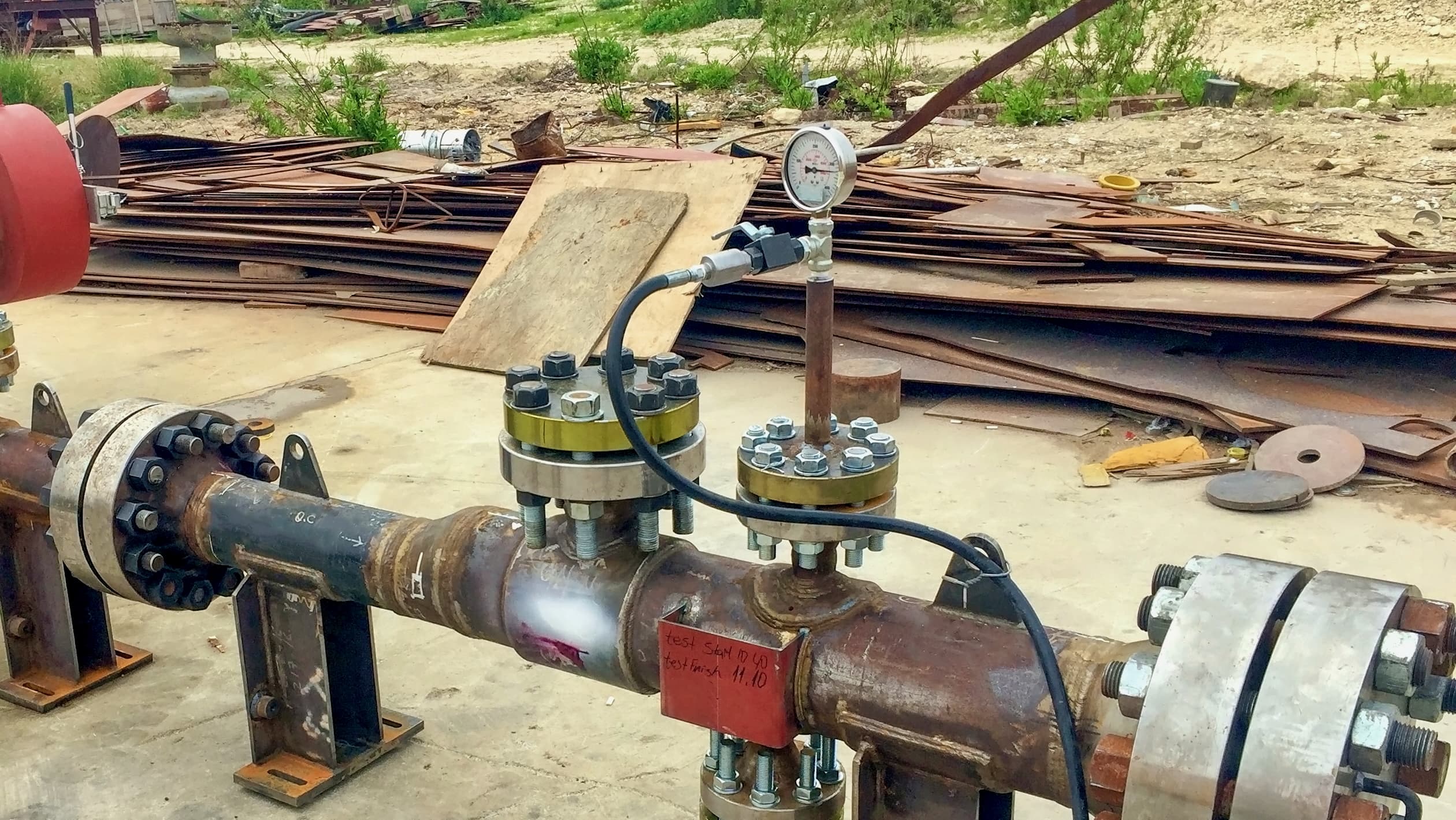 Hydrostatic testing setup connected to metal piping in the field